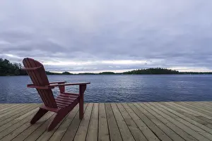 Known as Muskoka or Adirondack chairs sit on a dock at a resort in Muskoka