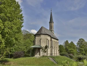 The Kummernis Chapel on the Hechenberg in Burghausen in sunshine and blue sky with white clouds