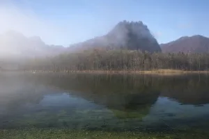 Lake Almsee in autumn with the mountain Ameisstein behind