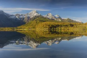 Lake Almsee in autumn with mountains reflected in the lake