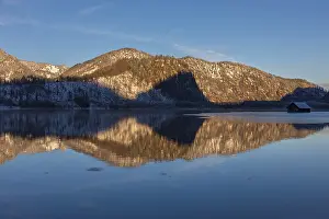 Lake Almsee in winter. Snow on the mountains and a clear blue sky