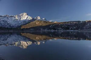 Lake Almsee in winter. Snow on the mountains and a clear blue sky