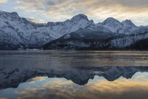 Lake Almsee in winter. Snow on the mountains and some clouds in the sky