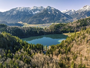 Lake in the forest with mountain panorama