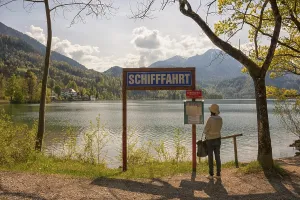 Lake Kochel, tourist reads the navigation map