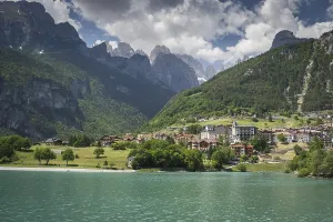 Lake Molveno is nestled between mountains in the Dolomites