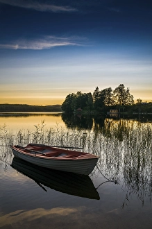Category Scandinavia Prints: Lake and rowing boat at sunset in Bengtsfors