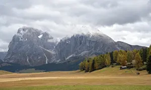 Landscape autumn meadow field. Dolomite rocky peaks
