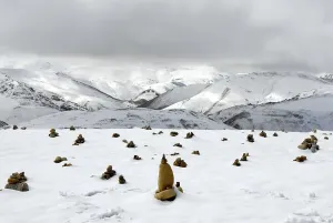 Landscape, cairns in the snow, mountains