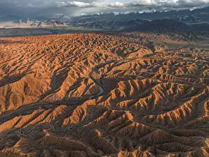 Landscape of eroded hills, badlands at sunset