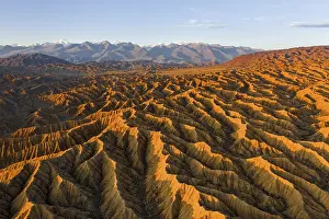 Landscape of eroded hills, badlands at sunset