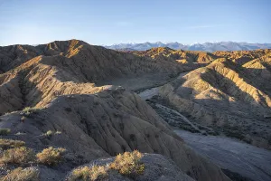 Landscape of eroded hills with canyon at sunrise