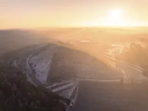 Landscaped hills in the pink-yellow light of sunrise