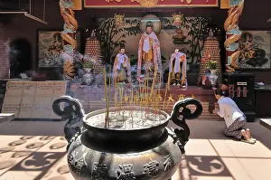 Large copper kettle with smoked foods in front of a Buddha altar