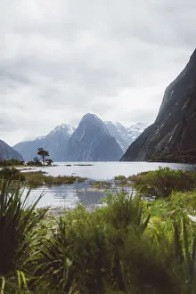 Large lake surrounded by high mountains and green vegetation