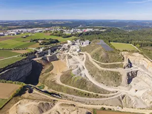 A large quarry with surrounding fields and forests from the air