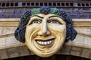 Category Cities DE Prints: Large, smiling face made of stone and wood