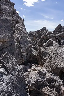 Large, weathered lava rocks under a clear blue sky