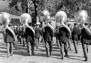 Five large wind instruments during a parade ca