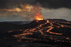 Lava spurting out of crater and reddish illuminated smoke cloud, lava flows, erupting volcano, Fagradalsfjall table volcano, Krysuvik volcano system, Reykjanes Peninsula, Iceland, Europe