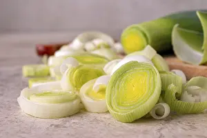 Leek cut into slices on a wooden board