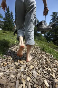 Legs of a barefoot hiker, adventure hiking trail