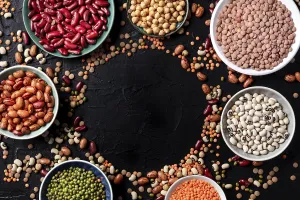 Legumes assortment, shot from the top on a black background with a place for text