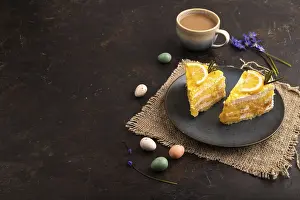 Lemon cake on black concrete background and linen textile
