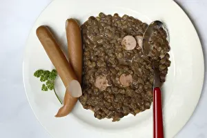 Lentil (Lens culinaris) dish with sausages on plate