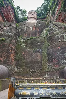 Leshan, China - July 2019 : Memorial candles lit at the bottom of The Giant Leshan Buddha