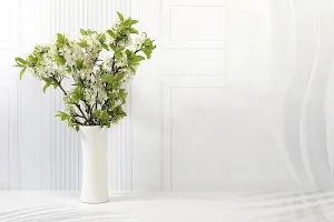 Still life with beautiful spring cherry blossom branches in vase on elegant background