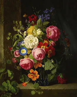 Still life with flowers in a blue crystal vase