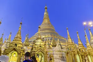 Light illuminates majestic stupas at night in a temple complex