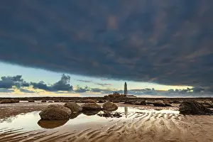 Lighthouse, St. Mary's Lighthouse at low tide with clouds at sunrise