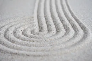 Lines and circle formation on beach sand with customizable space for text