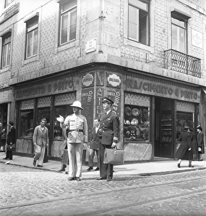 Lisbon, Portugal, 1949. A swedish airline captain in his uniform is being given directions by a policeman who is standing in a street corner, pointing with his hand where to go. Kristoffersson ref AR86-2, Europe