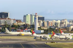 Lisbon, Portugal - Apr 24, 2024: TAP and Vueling airplanes parked at Lisbon airport on sunny day