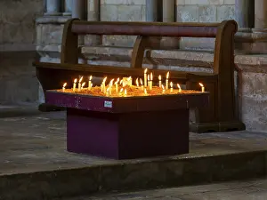 Lit candles burning inside cathedral