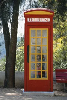 Little boy in English telephone box