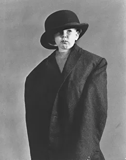 Little boy in large coat and hat