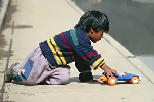 Little boy playing with toy car
