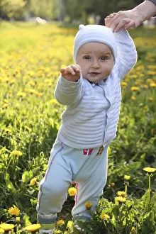 Little boy toddler staying on the grass