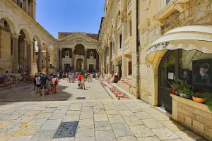 Lively historic square with architectural details and visitors