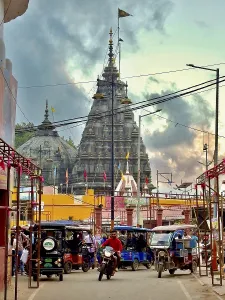 Lively scene with temples in the background and colourful city life