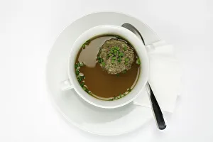 Liver dumplings in beef broth, sprinkled with chives