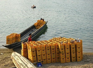 Loading empty beer crates, Ban Houa Det beach