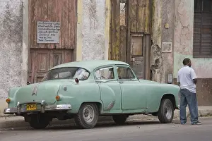 Local man standing next to a classic car
