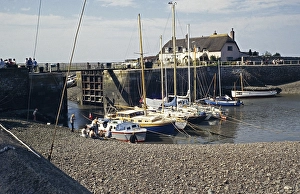 Lock gate and boats in the harbour of Porlock Quay, Somerset, England, Great Britain 1970s
