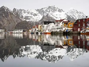 The Lofoten mountains being reflected in the water of the harbour of Henningsvaer