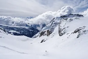 Lone ski tourer descending in fresh snow